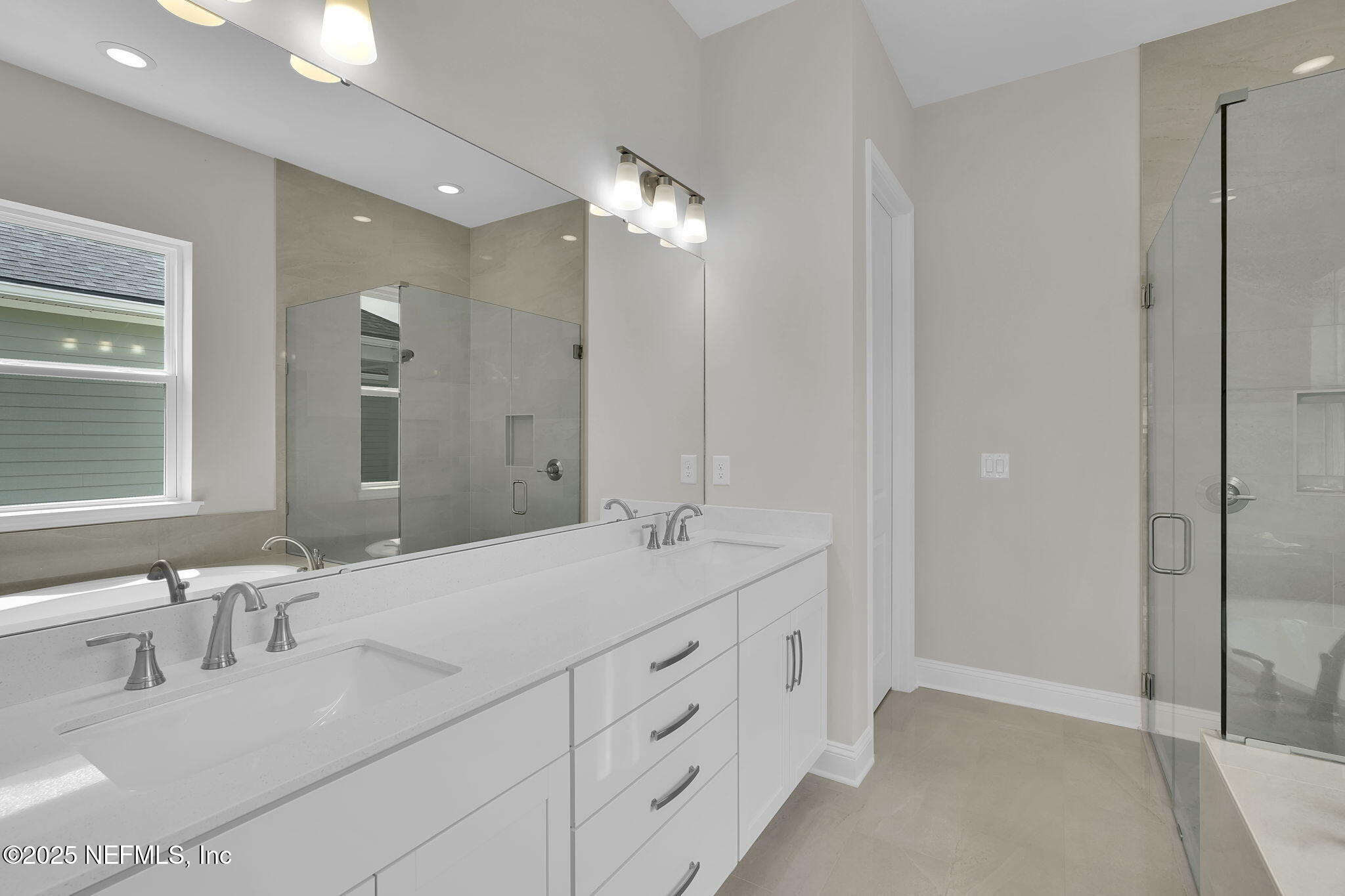 323 Sawgrass Drive Yulee, FL 32097 - Photo 29 of 48 a spacious bathroom with double sink and a mirror