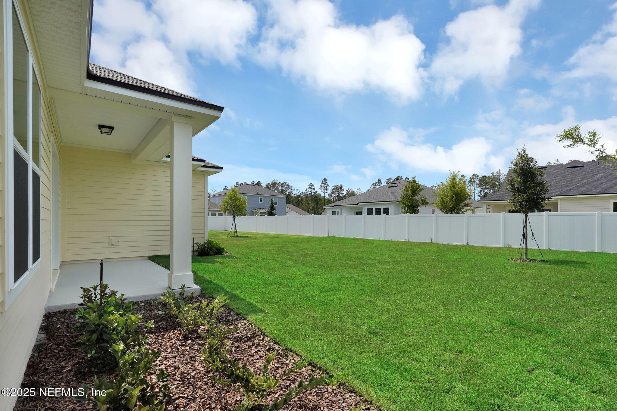 323 Sawgrass Drive Yulee, FL 32097 - Photo 34 of 48 a backyard of a house with lots of green space