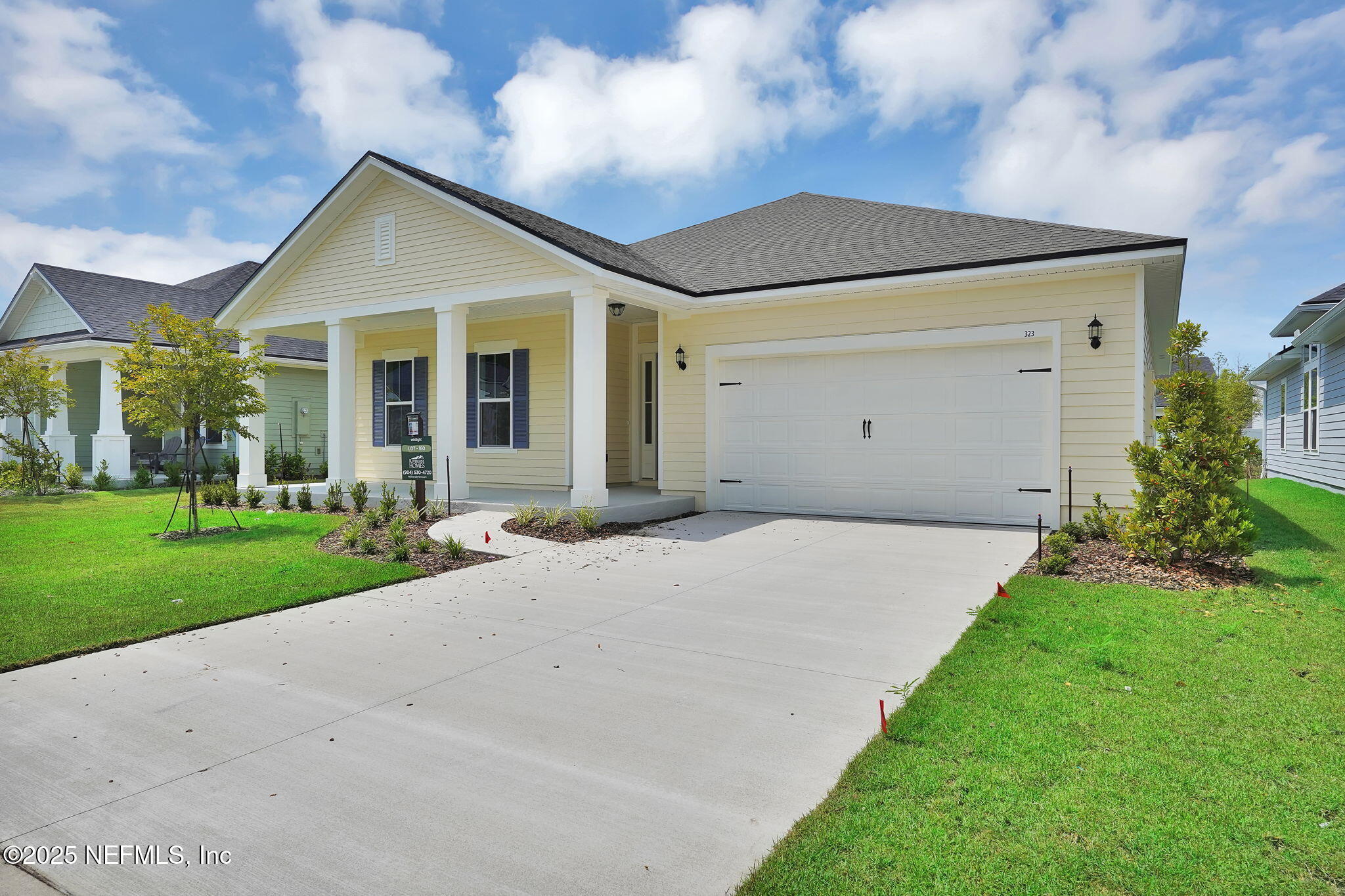 323 Sawgrass Drive Yulee, FL 32097 - Photo 4 of 48 a front view of a house with a yard and garage