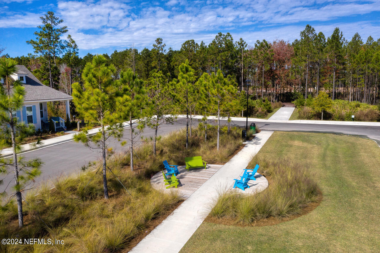 323 Sawgrass Drive Yulee, FL 32097 - Photo 42 of 48 a view of a swimming pool with a yard