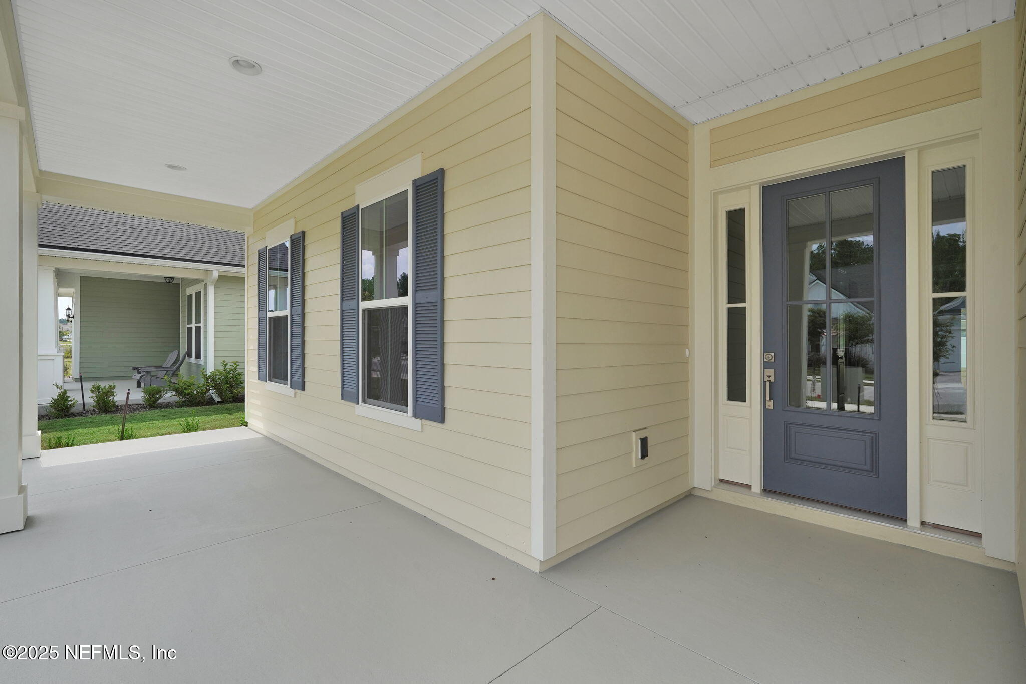 323 Sawgrass Drive Yulee, FL 32097 - Photo 9 of 48 a view of an empty room with window and hardwood
