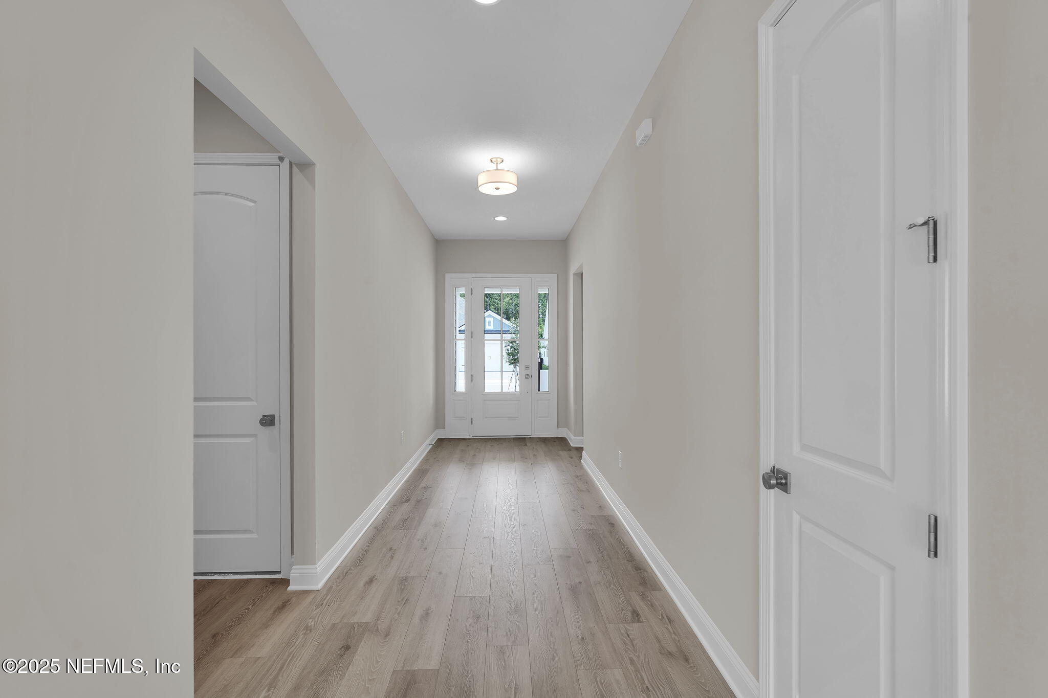 323 Sawgrass Drive Yulee, FL 32097 - Photo 10 of 48 a view of a hallway with wooden floor
