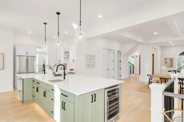 a kitchen with stainless steel appliances kitchen island granite countertop a sink a center island a refrigerator and a stove