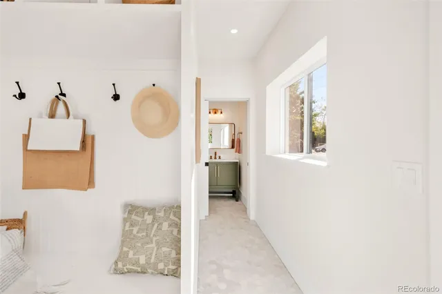 a view of a workspace with furniture and a window
