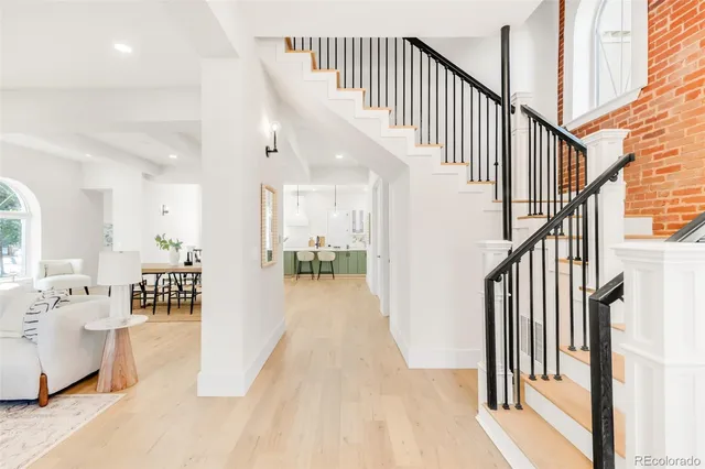 a view of entryway and hall with wooden floor