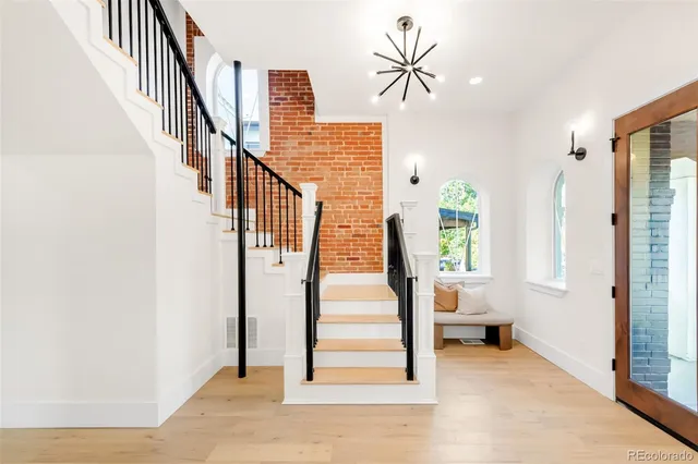 a view of a room with wooden floor and a window