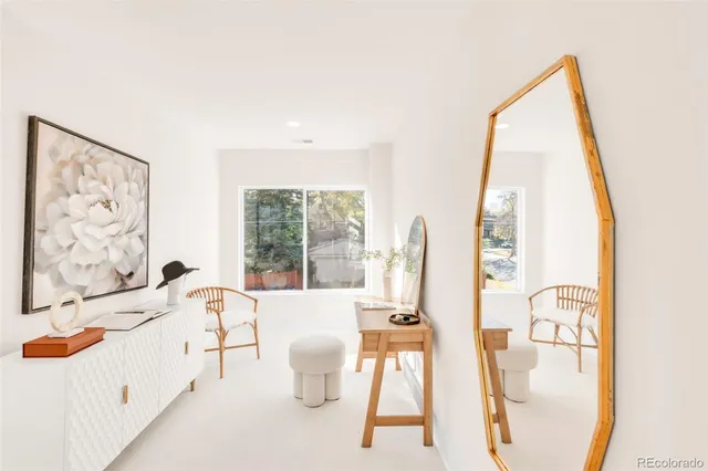 a bedroom with a bed mirror and a potted plant