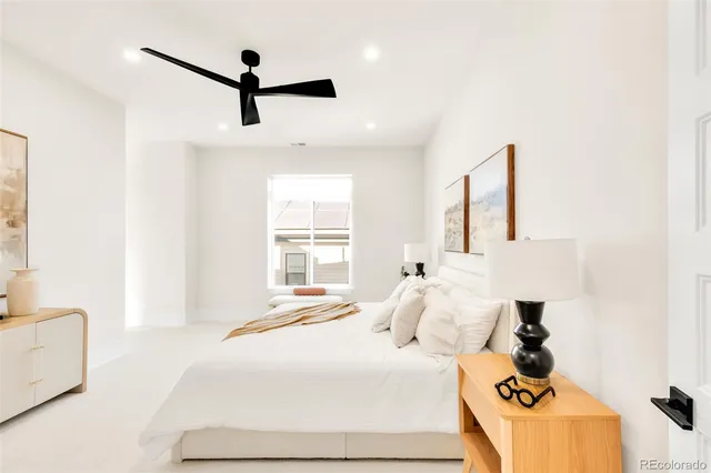 a bedroom with a bed and a painting