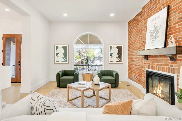 a living room with furniture fireplace and window