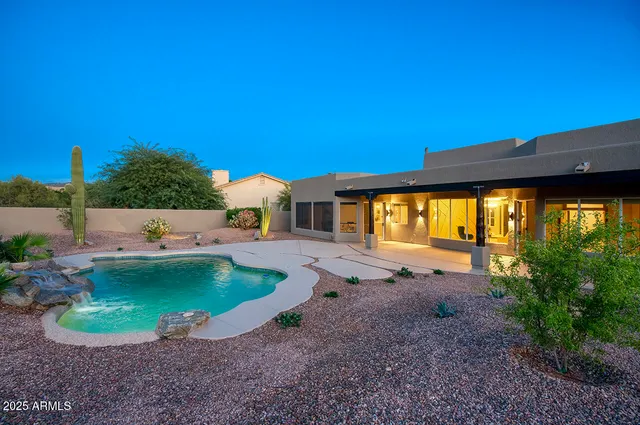 a view of backyard with swimming pool and outdoor seating