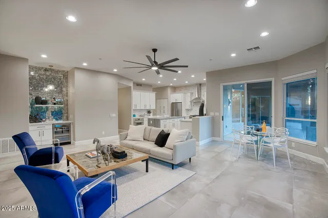 a living room with furniture kitchen and a table