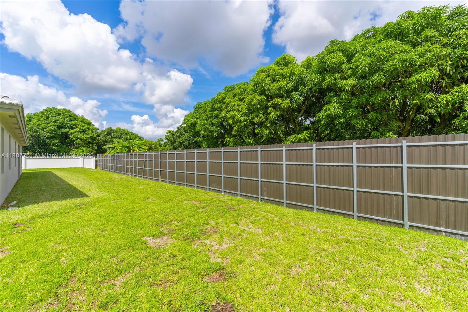 13283 Southwest 188th Terrace Miami, FL 33177 - Photo 14 of 54 a view of a yard with a wooden fence