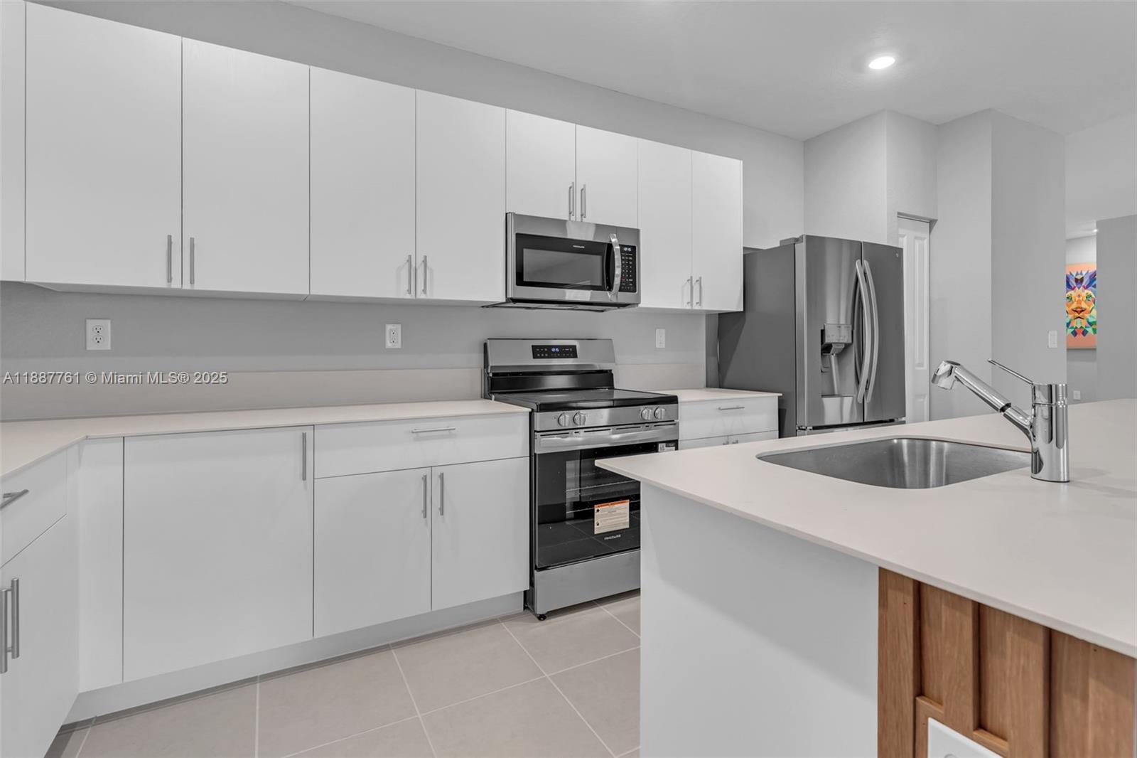 13283 Southwest 188th Terrace Miami, FL 33177 - Photo 23 of 54 a kitchen with cabinets appliances a sink and a counter top