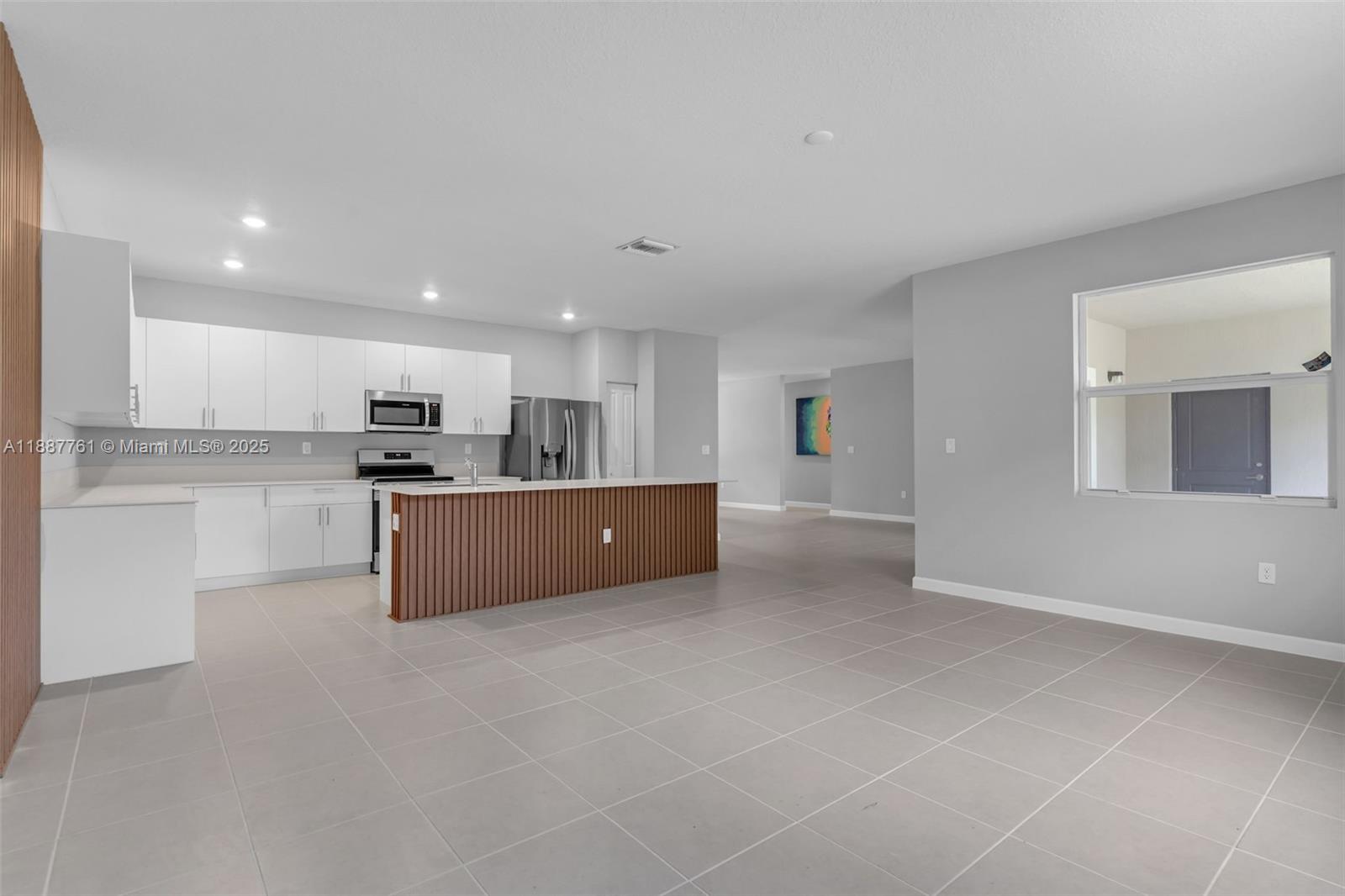 13283 Southwest 188th Terrace Miami, FL 33177 - Photo 24 of 54 a large kitchen with cabinets and stainless steel appliances