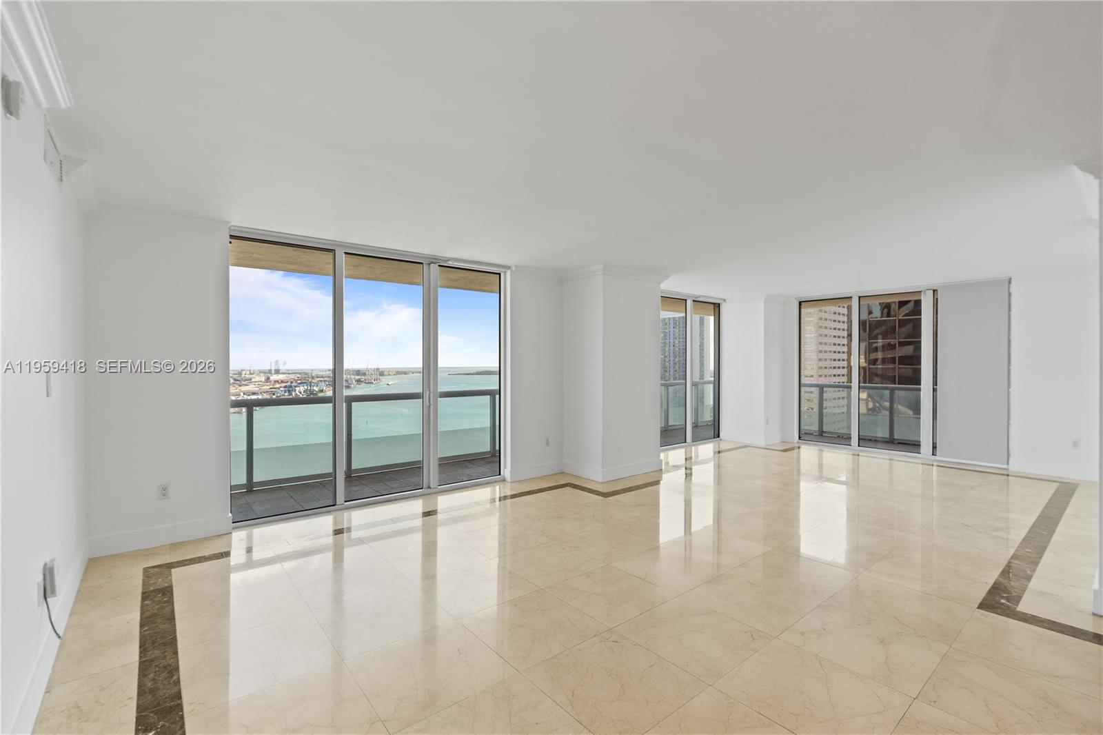 50 Biscayne Boulevard, Unit 3010 Miami, FL 33132 - Photo 12 of 50 wooden floor in an empty room with a window