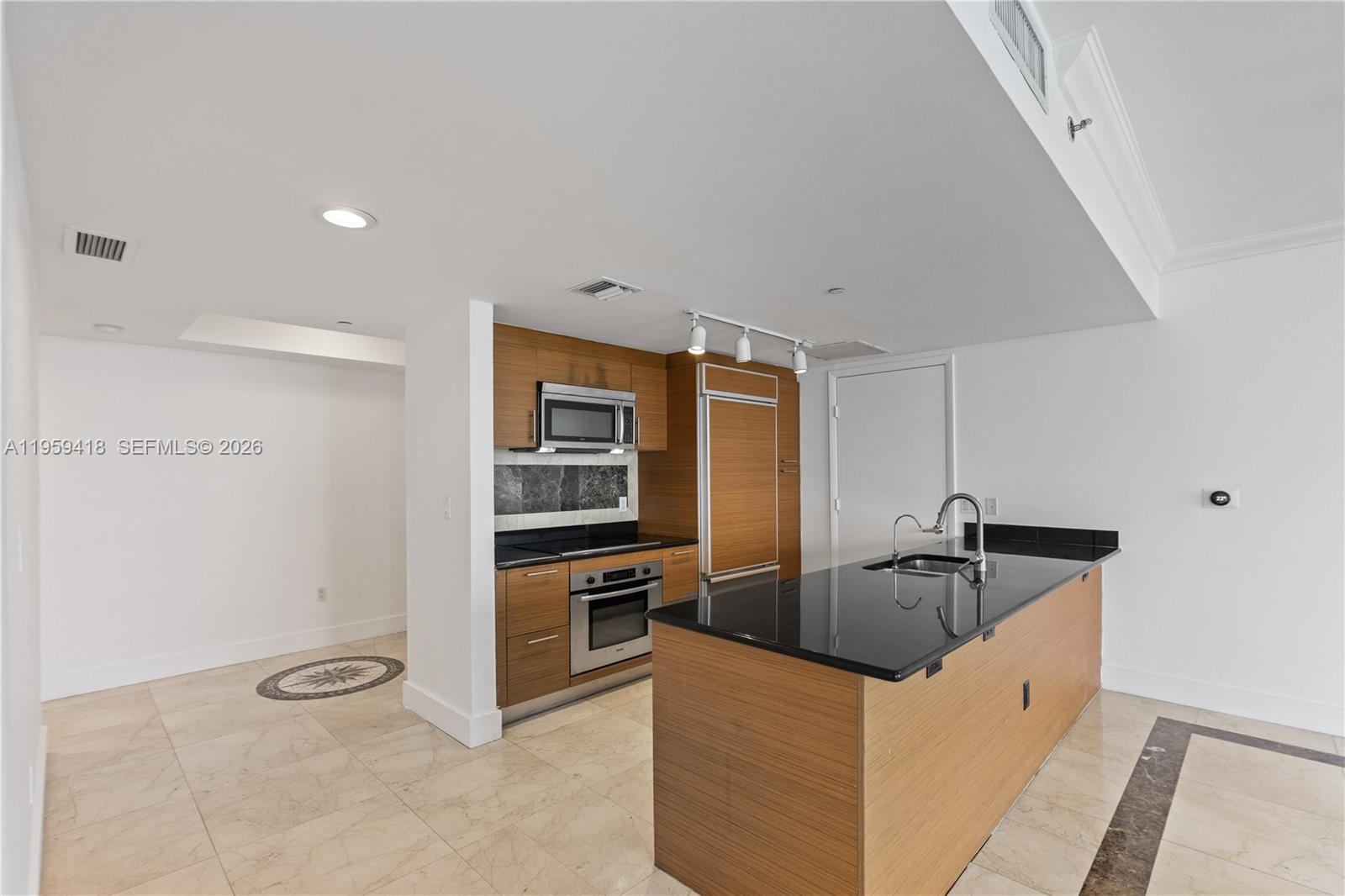50 Biscayne Boulevard, Unit 3010 Miami, FL 33132 - Photo 16 of 50 a kitchen with stainless steel appliances granite countertop a sink and a refrigerator