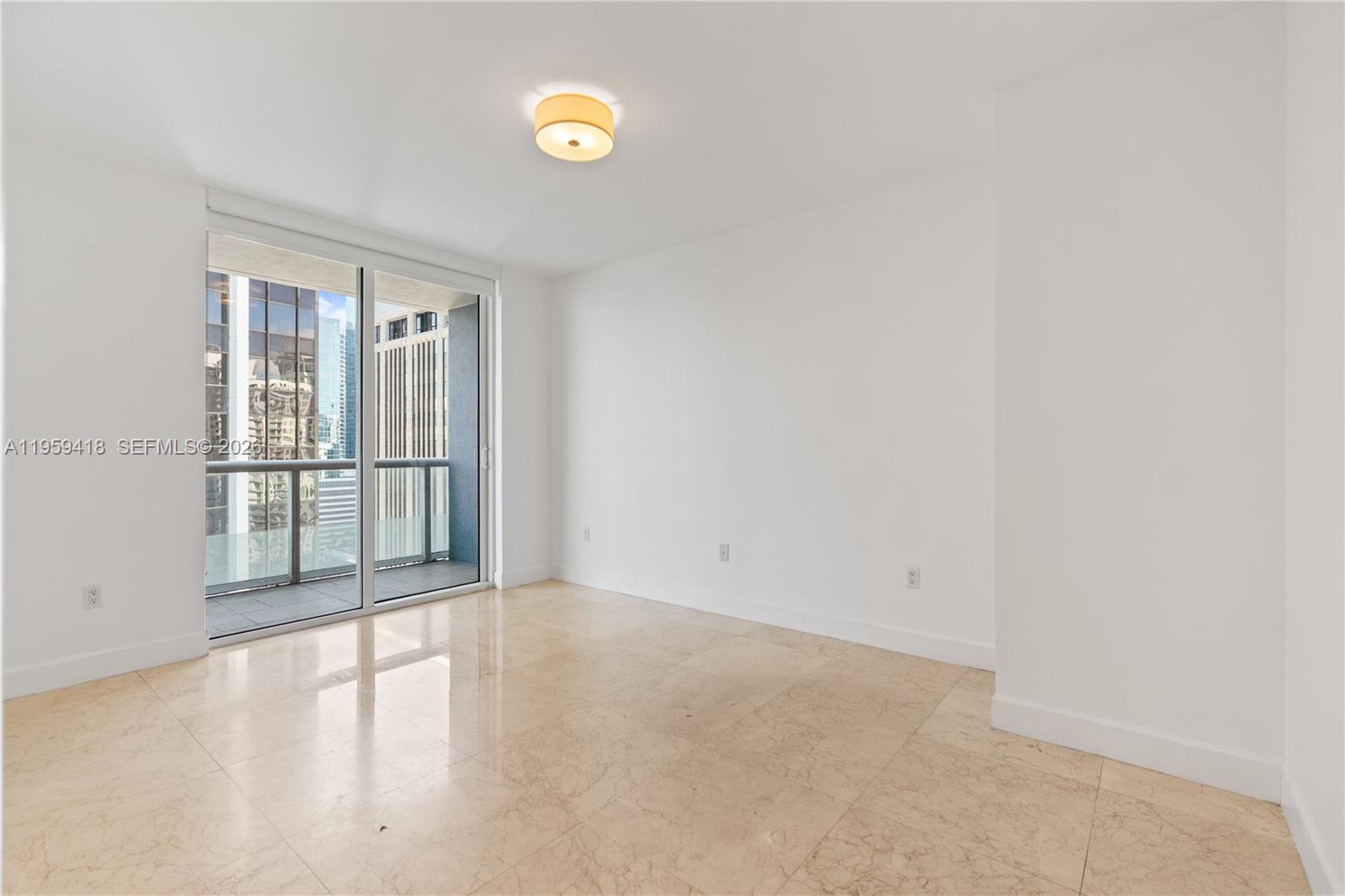 50 Biscayne Boulevard, Unit 3010 Miami, FL 33132 - Photo 28 of 50 an empty room with wooden floor and windows