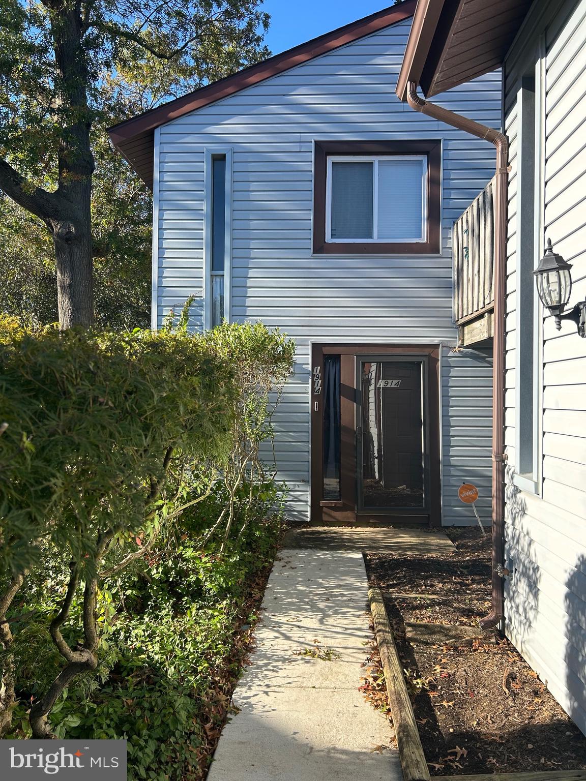 a view of a house with potted plants