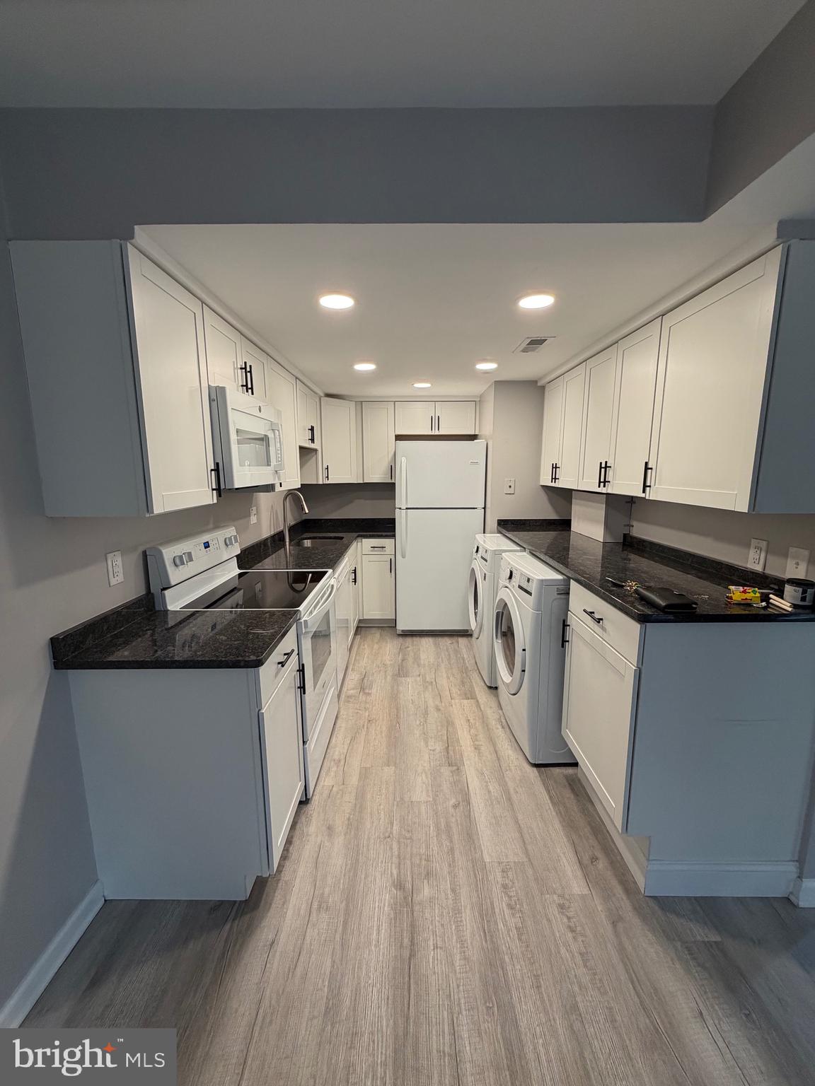 1914 Cavalier Circle, Unit A Crofton, MD 21114 - Photo 4 of 10 a kitchen with stainless steel appliances granite countertop a stove a sink and a microwave