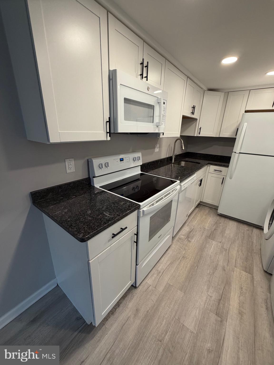 1914 Cavalier Circle, Unit A Crofton, MD 21114 - Photo 5 of 10 a kitchen with a sink a stove and cabinets