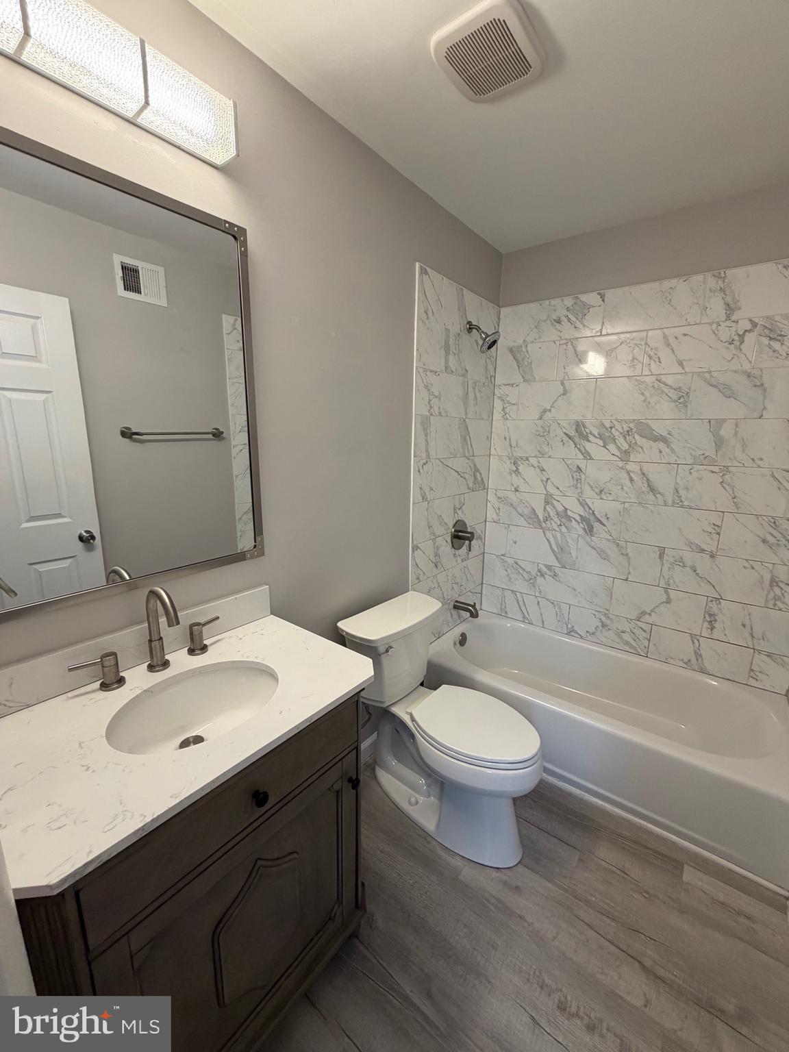 1914 Cavalier Circle, Unit A Crofton, MD 21114 - Photo 8 of 10 a bathroom with a sink a toilet a mirror and bathtub