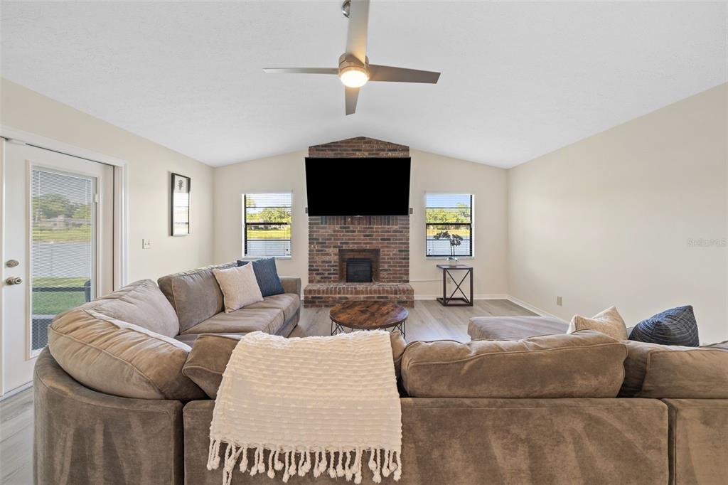 653 Timber Pond Drive Brandon, FL 33510 - Photo 21 of 56 a living room with furniture a fireplace and a flat screen tv