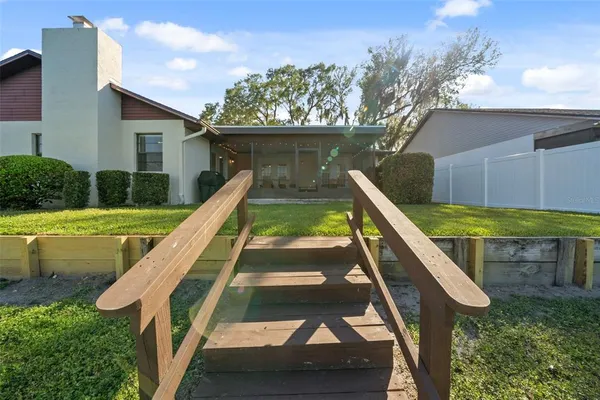 a view of a house with swimming pool and sitting area