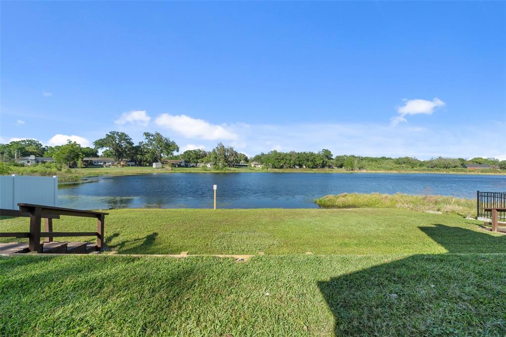 653 Timber Pond Drive Brandon, FL 33510 - Photo 42 of 56 a view of a lake with houses in the back