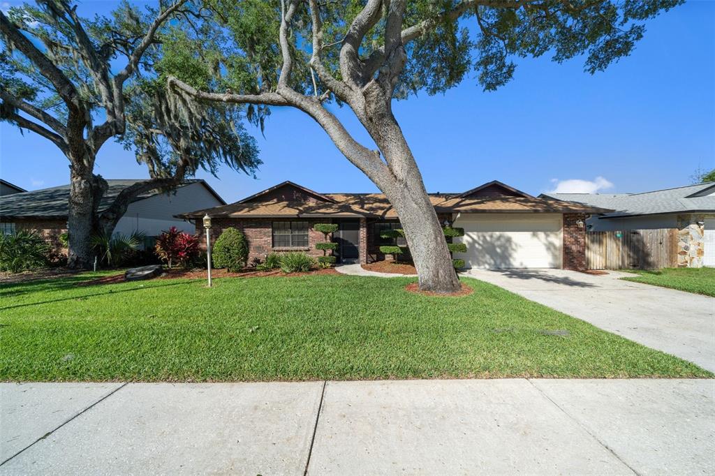 653 Timber Pond Drive Brandon, FL 33510 - Photo 47 of 56 a front view of a house with a yard table and chairs