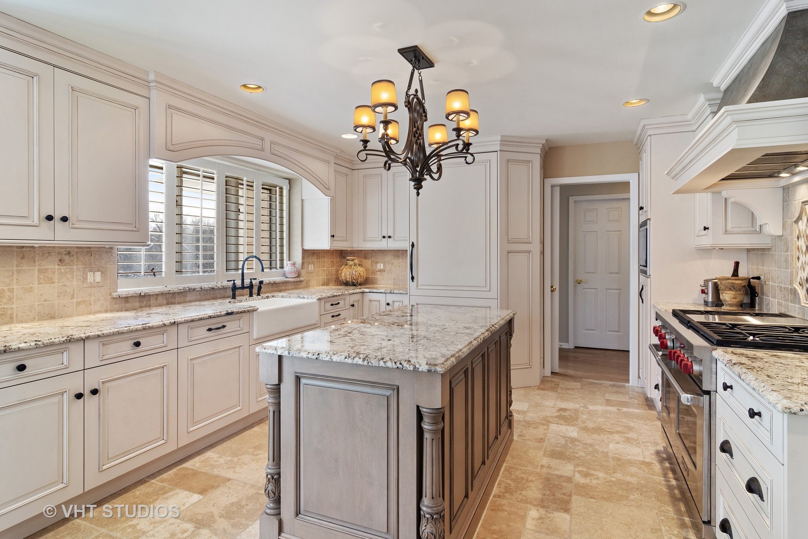 129 Knockderry Lane Inverness, IL 60067 - Photo 4 of 34 a kitchen with a sink dishwasher a stove a dining table and chairs with wooden floor