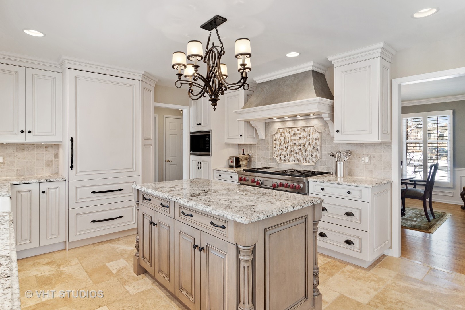 129 Knockderry Lane Inverness, IL 60067 - Photo 7 of 34 a kitchen with a stove a sink a chandelier and living room view