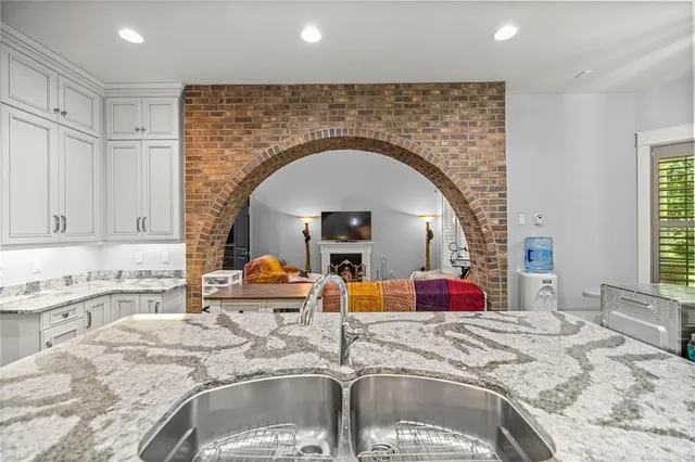 a kitchen with a sink and a granite counter tops