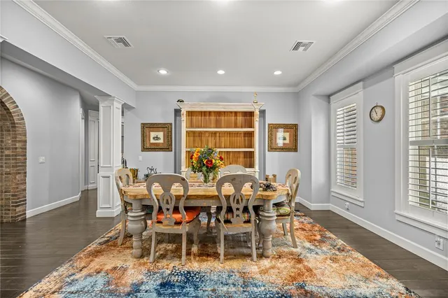 a dining room with furniture a rug and wooden floor