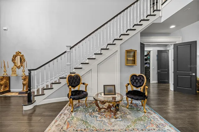 a view of entryway and hall with wooden floor