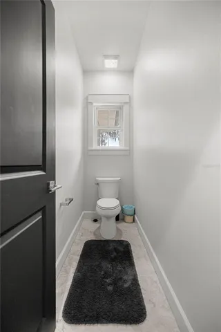 a bedroom with a bed and a flat screen tv on dresser