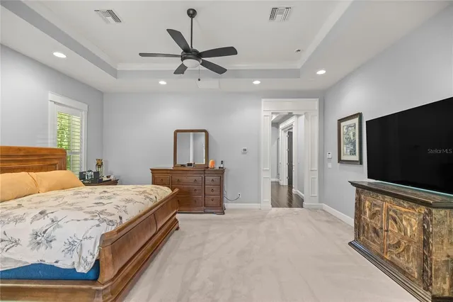 a bedroom with a bed couch and window