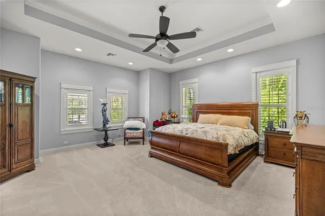 a bedroom with a bed a flat screen tv and a couch