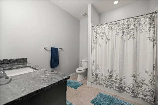 a view of room with a ceiling fan and window