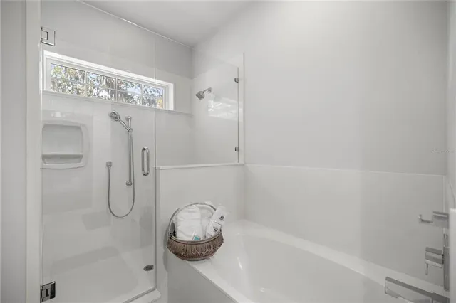 a view of a room with a ceiling fan and window