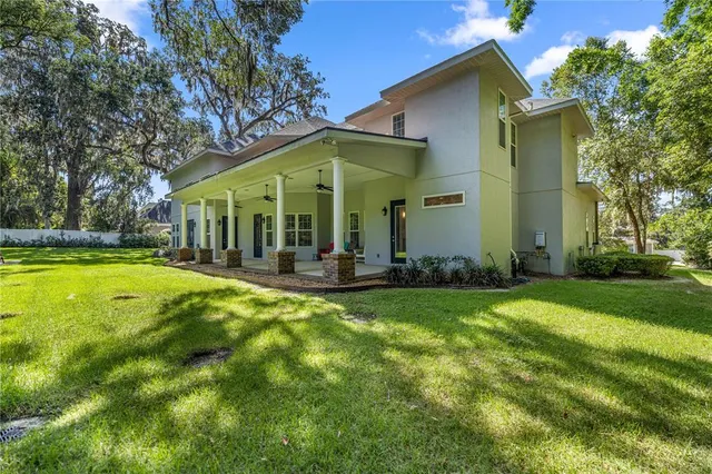 a view of a house with swimming pool and porch