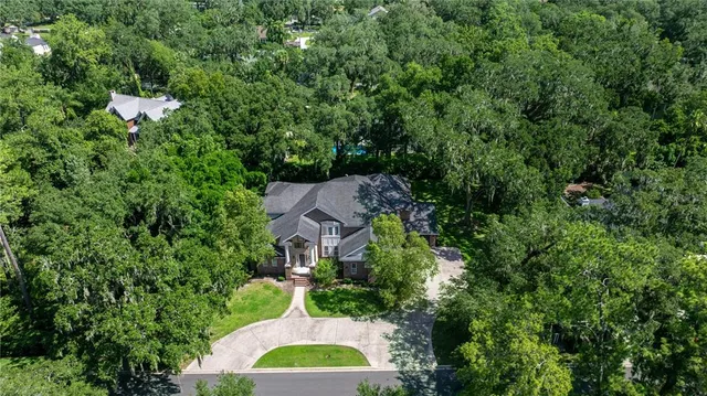 an aerial view of a house with yard swimming pool and outdoor seating