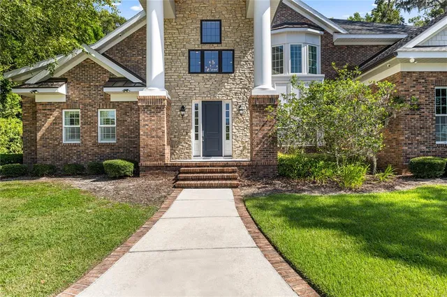 a front view of a house with a yard and porch