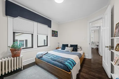 a bedroom with a bed and a potted plant