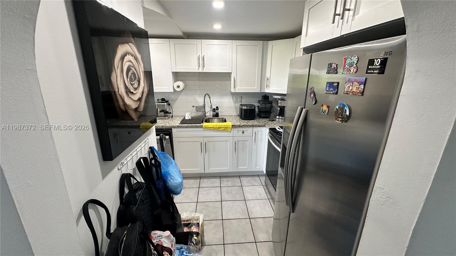 14250 Southwest 62nd Street, Unit 517 Miami, FL 33183 - Photo 17 of 47 a view of a kitchen with fridge and a sink