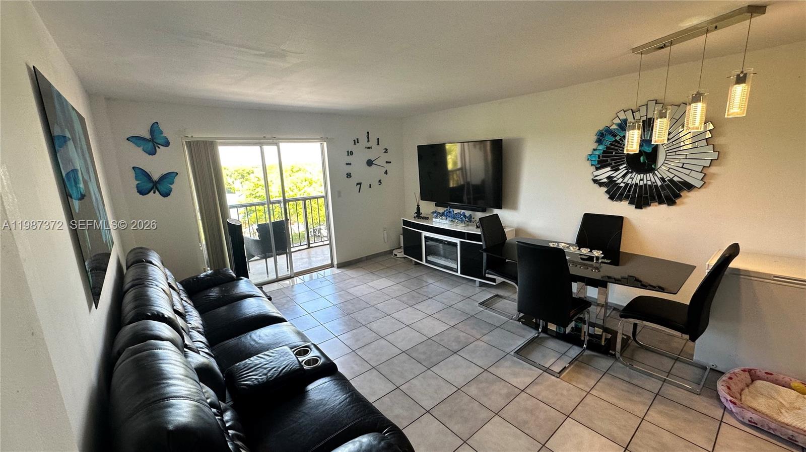 14250 Southwest 62nd Street, Unit 517 Miami, FL 33183 - Photo 19 of 47 a living room with furniture and a flat screen tv