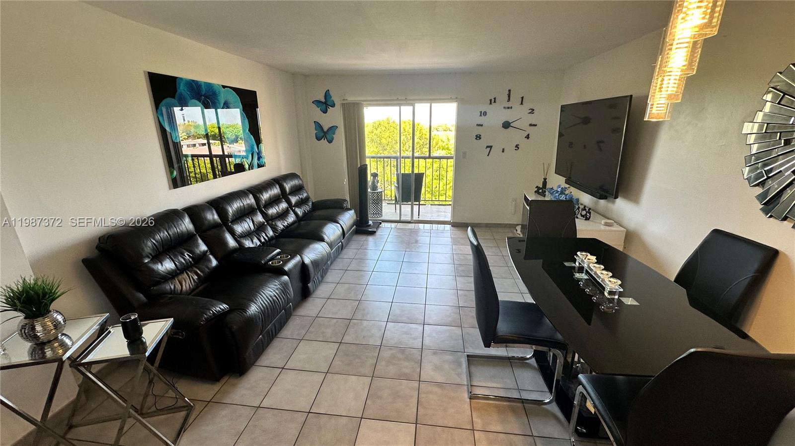 14250 Southwest 62nd Street, Unit 517 Miami, FL 33183 - Photo 20 of 47 a living room with furniture and a flat screen tv