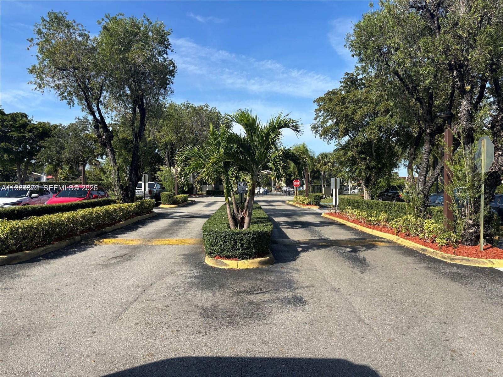 14250 Southwest 62nd Street, Unit 517 Miami, FL 33183 - Photo 2 of 47 a view of a park with large trees