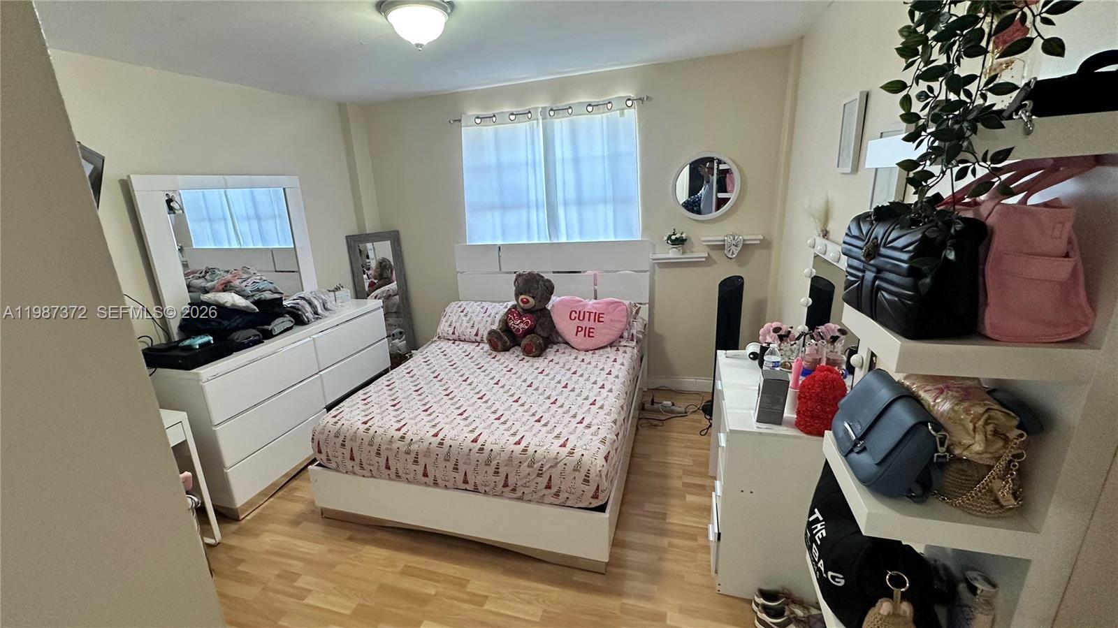 14250 Southwest 62nd Street, Unit 517 Miami, FL 33183 - Photo 24 of 47 a bedroom with a bed and a potted plant