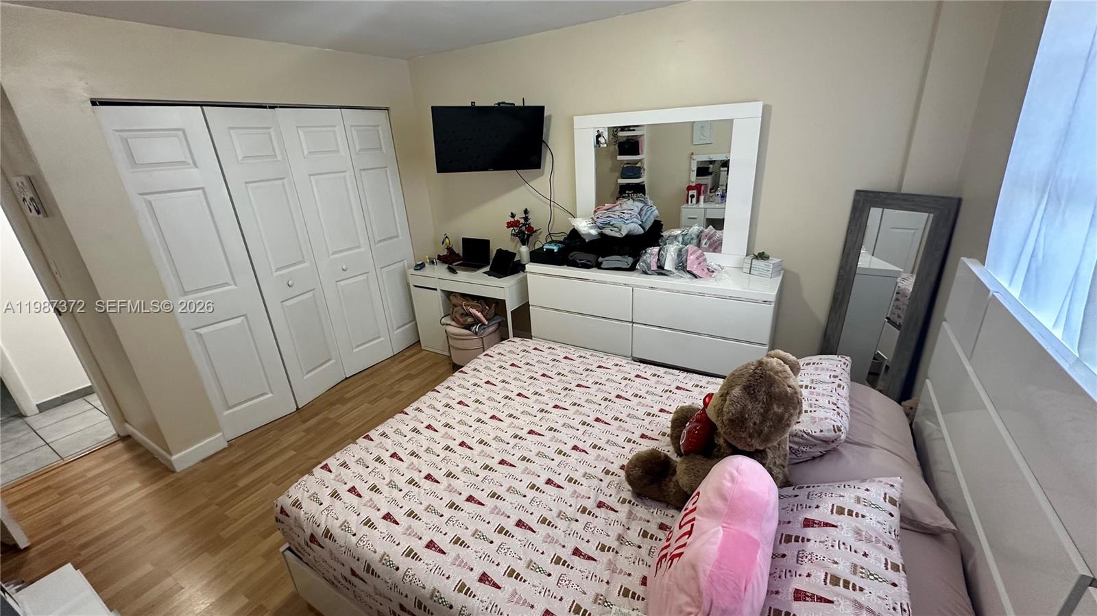 14250 Southwest 62nd Street, Unit 517 Miami, FL 33183 - Photo 25 of 47 a bedroom with a bed and a flat tv screen on the dresser