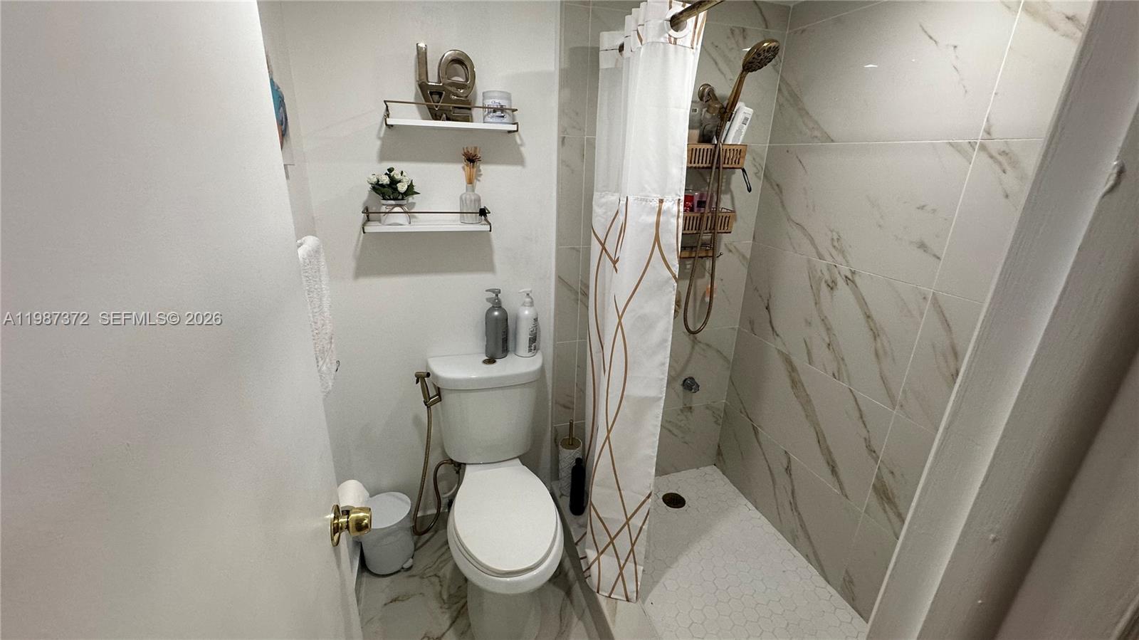 14250 Southwest 62nd Street, Unit 517 Miami, FL 33183 - Photo 28 of 47 a bathroom with a toilet and a sink